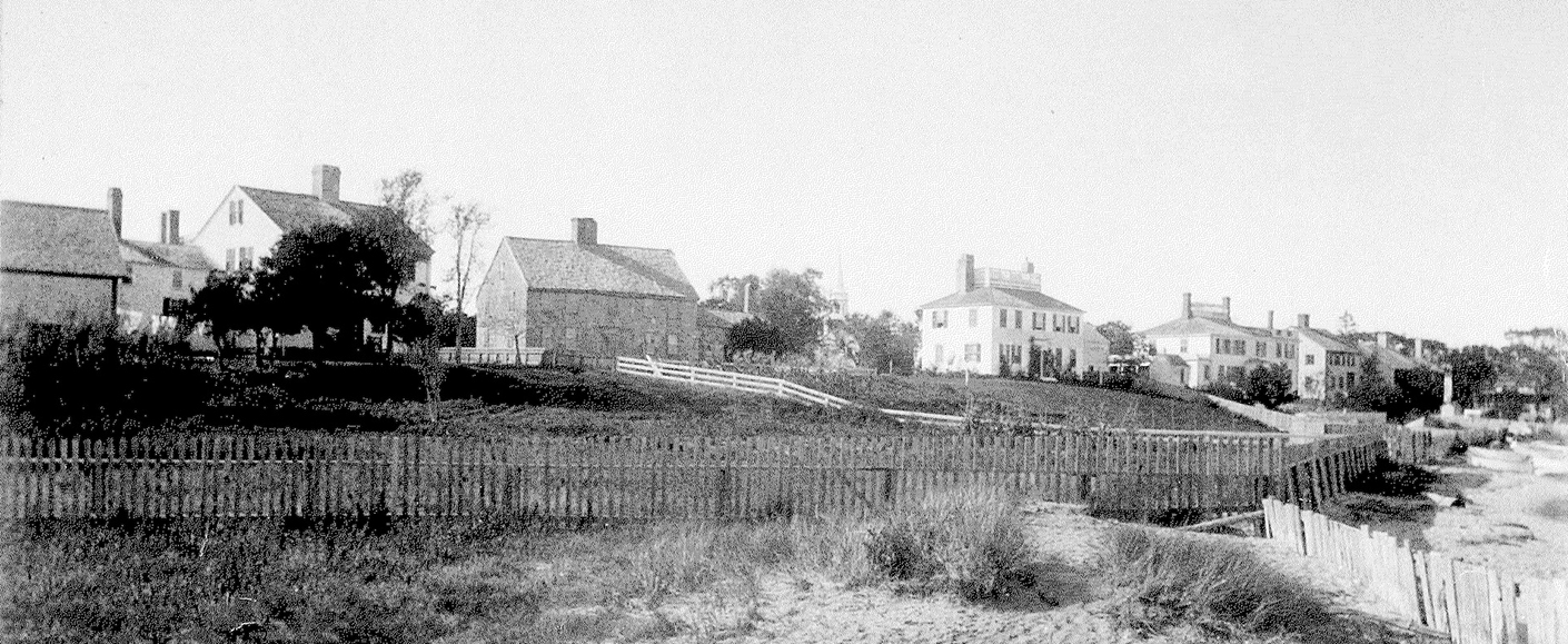 View of South Water Street from the harbor side featuring captain’s homes with widow’s walks (including Captain Grafton Collins’ House) around 1890.