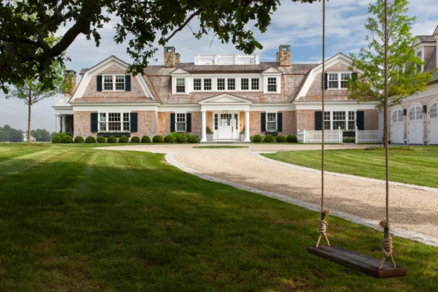 Rooted in history and built for generations, this shingle and stone gambrel was thoughtfully designed to honor the site’s legacy and support a growing family's future. In the foreground, a handcrafted swing offers a quiet moment within the estate’s carefully curated landscape.

Read the full story in the June/July issue of Ocean Home magazine.

Architecture: @patrickahearnarchitect 
Builder: @jbrobbiecustomhomes 
Photo Credit: @taylor.allegrini 
Publisher: @oceanhomemag