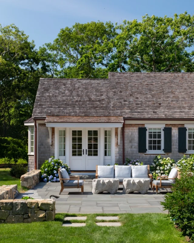 An outdoor living space that feels as though it’s always been part of the Martha’s Vineyard landscape. Weathered shingles, timeless lines, and a grounded bluestone patio create a sense of permanence and ease. Though new construction, every detail is designed to honor tradition while welcoming modern life outdoors.

Architect: @patrickahearnarchitect 
Builder: @waterfrontbuildersmv 
Interior Designer: @goodbonesdesign 
Landscape: @donaromasmv 
Photo Credit: @taylor.allegrini