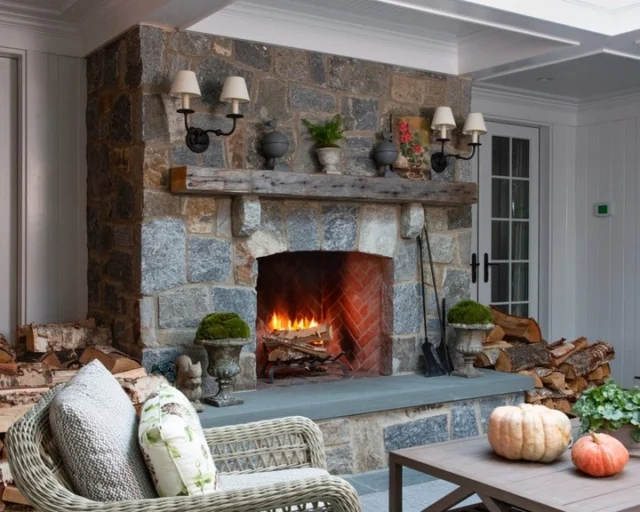 This screened porch in Wellesley Farms is warmed by a stone fireplace which anchors the space and invites guests to gather 'round no matter the weather.

Architecture: @patrickahearnarchitect
Builder: @sweeneycustomhomes
Interior Design: @charles_spada
Photo Credit: @taylor.allegrini