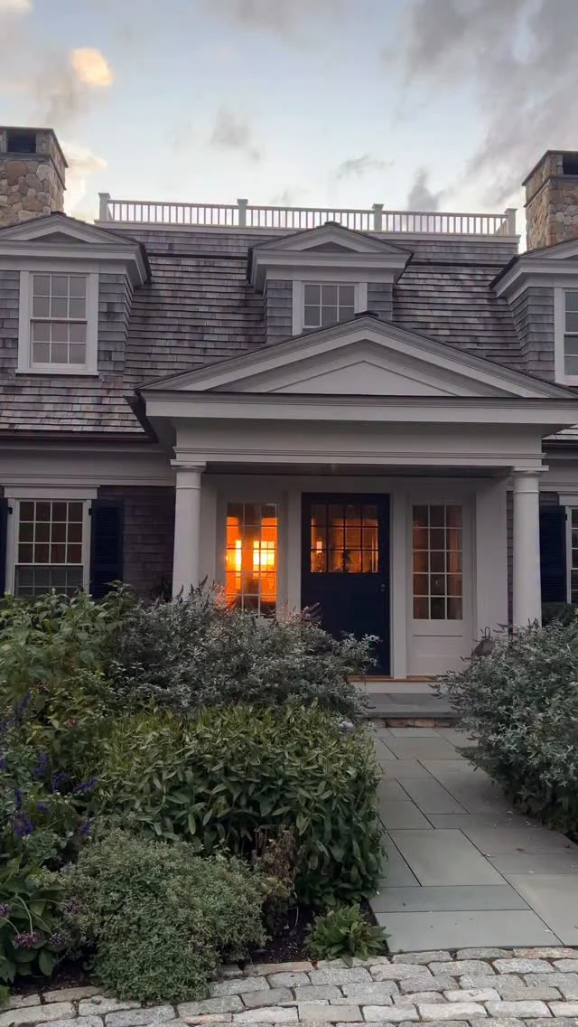 Sited on Slough Cove with views of Great Pond in the distance, this shingled gambrel legacy property glows at golden hour.

Architect: @patrickahearnarchitect 
Builder: @colonial_reproductions 
Interior Design: @trackerhomedecor 
Stylist: @cmack2002 
Photo Credit: @gregpremru