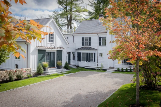 Sloping topography became an asset in the renovation and expansion of this historic Southborough farmhouse. A new arrival sequence features a street-level motorcourt and pea stone driveway flanked by the main residence on one side and a new carriage house wing on another. The drive gently wraps around the property, leading vehicles to bays smartly built into the grade below.

Architecture: @patrickahearnarchitect
Builder: Tom Finelli
Interior Designer: @beeskneesinteriordesign
Landscape Architect: @dangordonla
Photographer: @michaeljleephotography