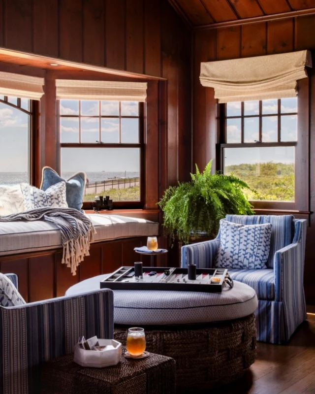 Framed by sweeping ocean views, this bay window seat and adjoining seating area capture the quiet beauty of Newport while honoring the home’s historic soul. Thoughtfully layered with soft textures and timeless details, this cozy retreat just off the living room invites year-round comfort and connection to the landscape.

Architecture: @patrickahearnarchitect
Builder: @pcciri
Interior Design: @tastedesigninc 
Landscape Architect: @dangordonlandscape