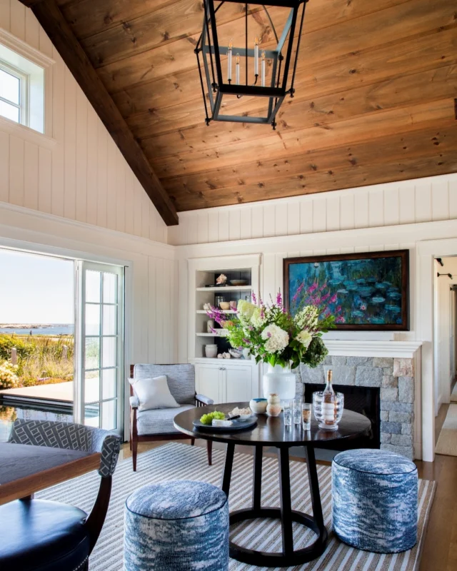 Just off the pool, a vaulted wood ceiling and stone hearth anchor this Newport seating area, where layered textures and open doors connect seamlessly to the landscape.

Architecture: @patrickahearnarchitect
Builder: @pcciri
Interior Design: @tastedesigninc
Landscape Architect: @dangordonlandscape