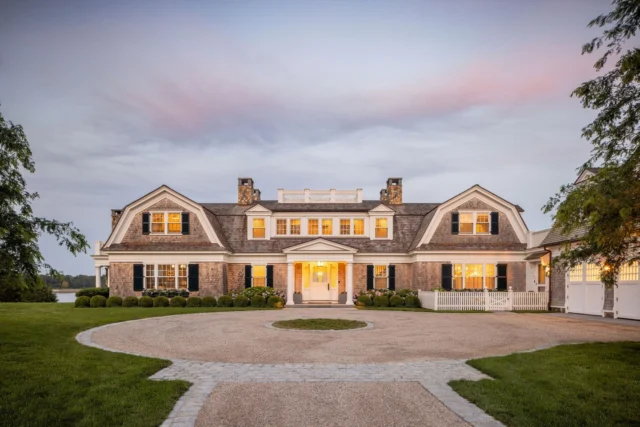 At dusk, this shingle and stone gambrel in Duxbury, MA settles quietly into the landscape, its warm light and balanced proportions creating a sense of calm permanence. Designed to feel both enduring and personal, it honors the site’s history while welcoming generations to come.

Architecture: @patrickahearnarchitect
Builder: @jbrobbiecustomhomes
Landscape: @leblancjones
Photo Credit: @crucinski_