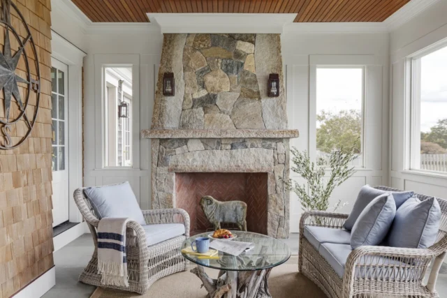 On Martha's Vineyard, this three-season porch is anchored by a prominent fieldstone-clad fireplace featuring herringbone brick on the interior.

Architecture: @patrickahearnarchitect
Builder: @colonial_reproductions
Interior Design: @trackerhomedecor
Photo Credit: @gregpremru
Styling: @cmack2002
