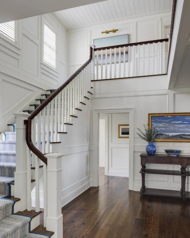 The stair tower within this newly built home on Martha's Vineyard turns a utilitarian space into a processional gallery where homeowners and family can enjoy their collection of artwork set against custom milled architectural wall paneling.

Architecture: @patrickahearnarchitect
Builder: @colonial_reproductions
Interior Design: @trackerhomedecor
Photo Credit: @gregpremru
Styling: @cmack2002