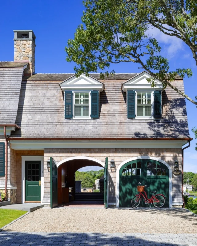 On Cape Cod, this timeless gambrel home features classic cedar shingles, regionally-appropriate New England fieldstone and bluestone, crisp white trim, and arched carriage house doors that swing open wide on two sides of the structure. See more of the residence in Patrick's new book Driven: The Road to Iconic Design - find the link to preorder in our bio.

Architecture: @patrickahearnarchitect
Builder: @mcpheebuilding
Photo Credit: @Gregpremru
