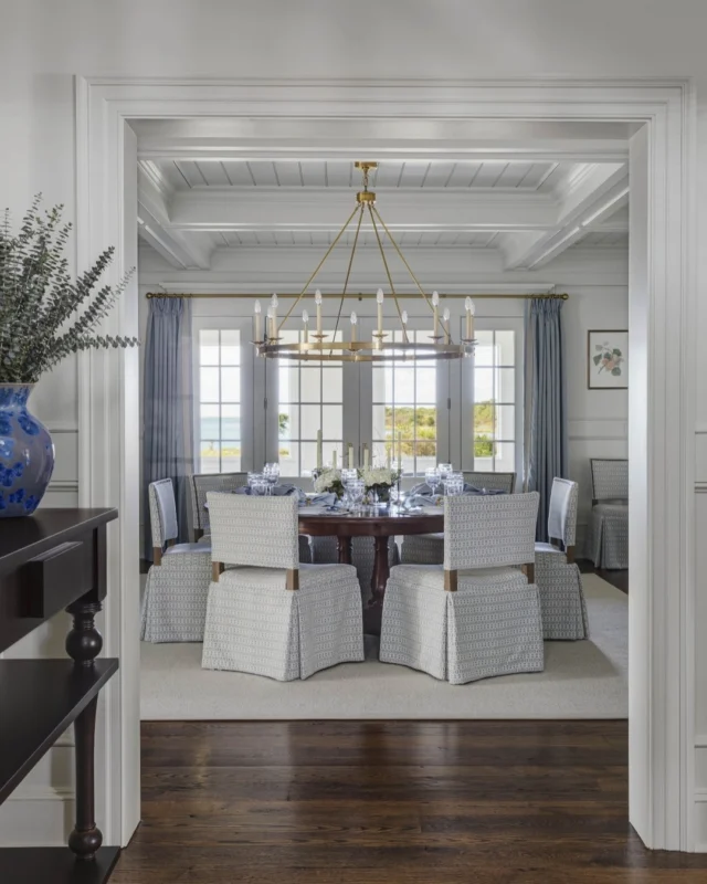 The formal dining room at this newly built residence within Edgartown's Herring Creek Farm offers layers of timeless architectural detail, including beadboard clad ceilings and cased beams overhead, architectural wall paneling, and a thick cased opening into the space.

Architecture: @patrickahearnarchitect
Builder: @colonial_reproductions
Interior Design: @trackerhomedecor
Photo Credit: @gregpremru
Styling: @cmack2002