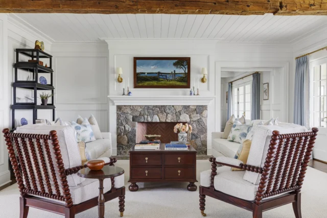 Sited on Edgartown's Herring Creek Farm, the formal living room within this newly built shingle style home beckons to guests to gather 'round the fieldstone fireplace before meandering out to the covered terrace just beyond the French doors.

Architecture: @patrickahearnarchitect
Builder: @colonial_reproductions
Interior Design: @trackerhomedecor
Photo Credit: @gregpremru
Styling: @cmack2002
