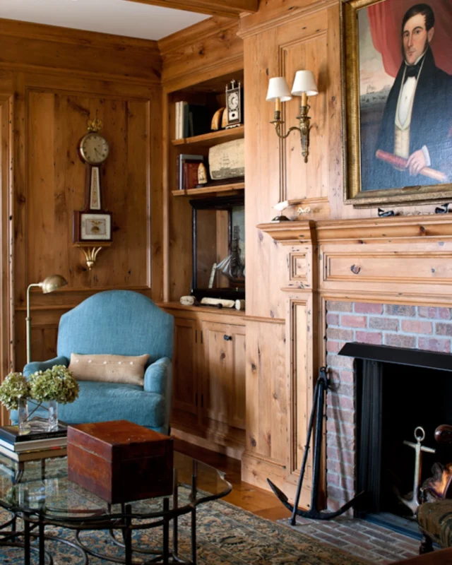 Character-rich knotty pine paneling and ceiling beams surround this glowing hearth within a timeless Edgartown residence, where substantial millwork and built-ins elevate the overall presentation of the room.

Architecture: @patrickahearnarchitect
Builder: @rosbeckbuilders
Interior Design: Gauthier-Stacy Inc.
Photo Credit: @gregpremru