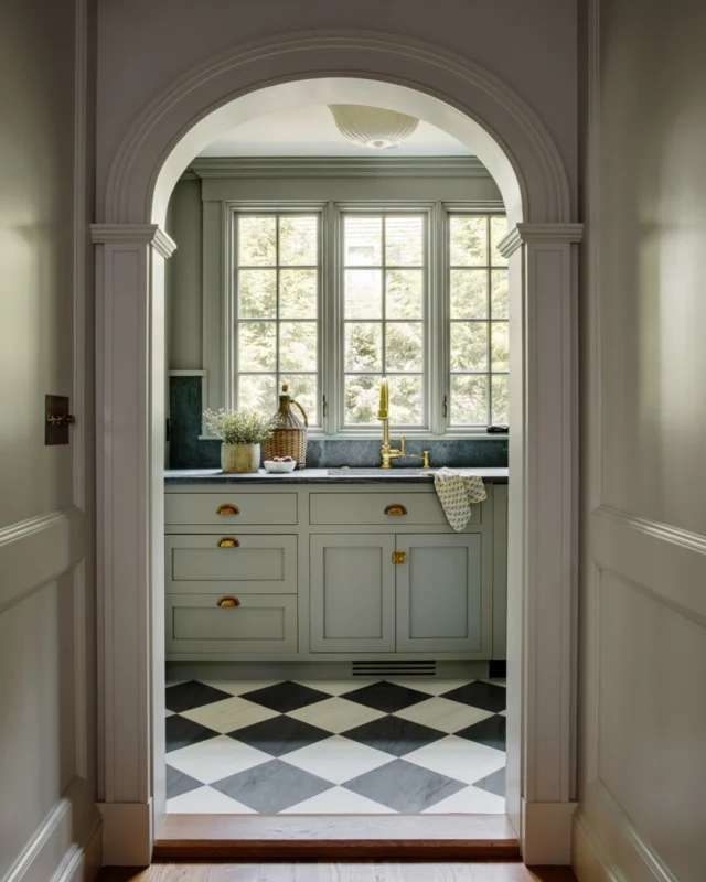 Within this revitalized Wellesley colonial, an arched passageway reveals a pantry defined by bespoke millwork, honed stone, and luminous brass accents. The checkered marble floor and oversized crown moldings lend timeless rhythm and architectural gravitas to the reimagined home.

Architecture: @Patrickahearnarchitect
Builder: @whitlabrothersbuilders
Interior Designer: @Vineyard_decorators
Photo Credit: @gregpremru